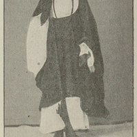 Targui avec la coiffure blanche ramenée au-devant du visage.